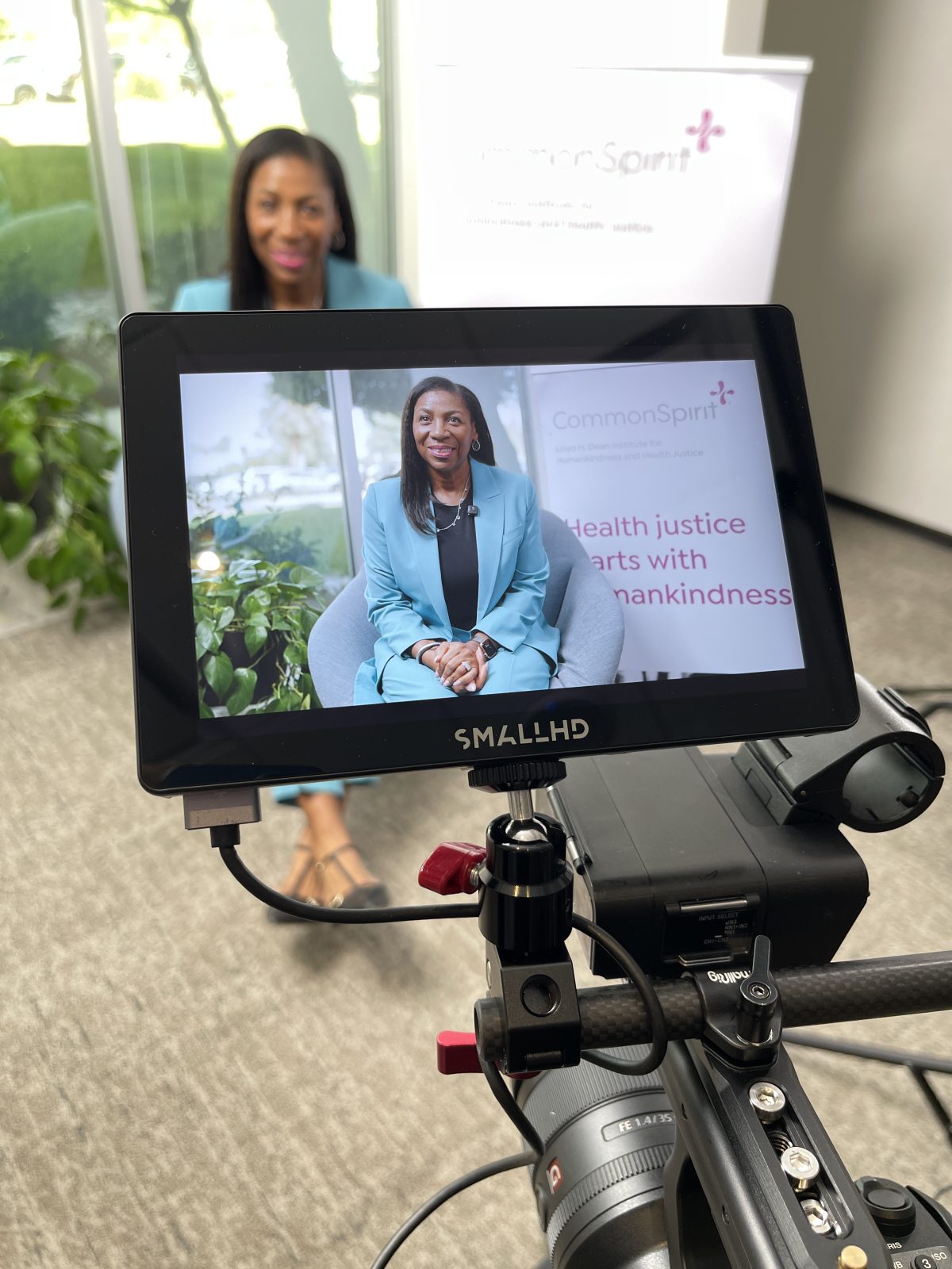 A field monitor showing the framed CommonSpirit interview shot during the video production