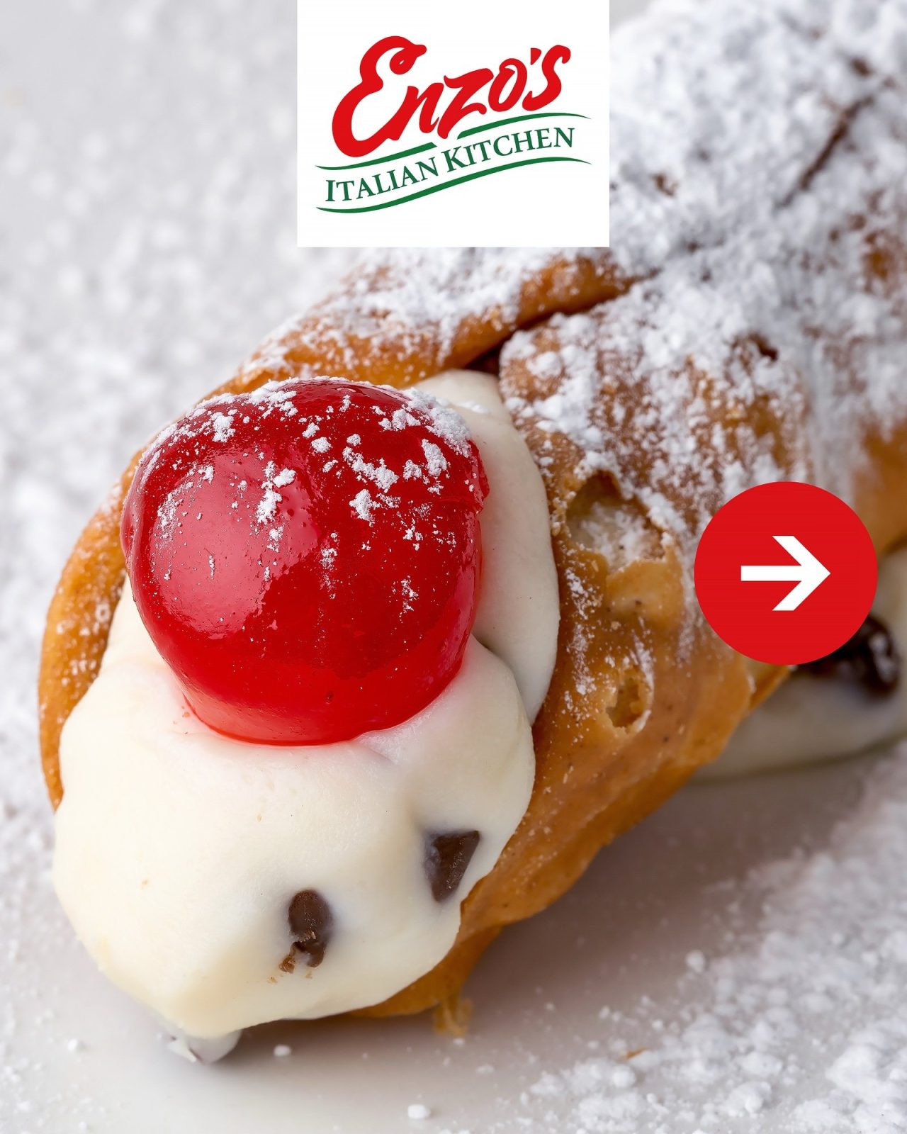 Cannoli with chocolate chip ricotta filling and a candied cherry, dusted with powdered sugar, at Enzo's Italian Kitchen