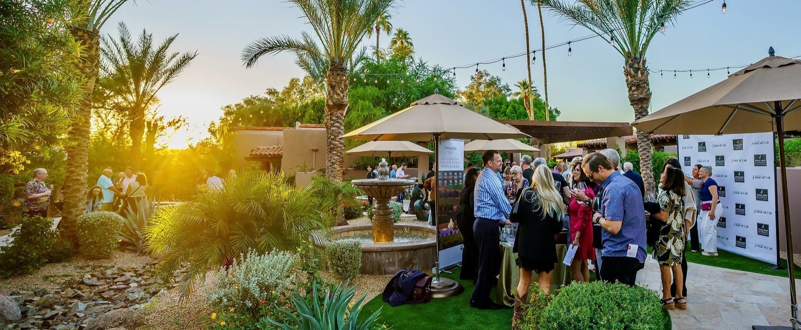 Guests gathered around the pour tables in the Hermosa Inn courtyard at sunset during House of Cab Phoenix, Paradise Valley