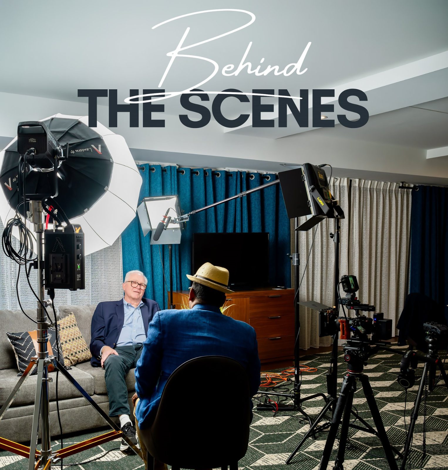 Behind the scenes of a testimonial video interview for National Network of Fiscal Sponsors at their Annual Conference in a Scottsdale hotel suite, with a lantern softbox, LED panels, a boom microphone and a cinema camera framed on the seated guest