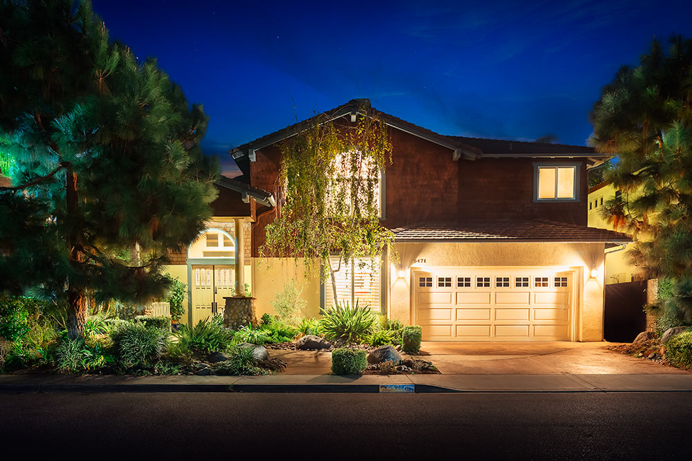 Glowing exterior photo of a home at night time in Oceanside California