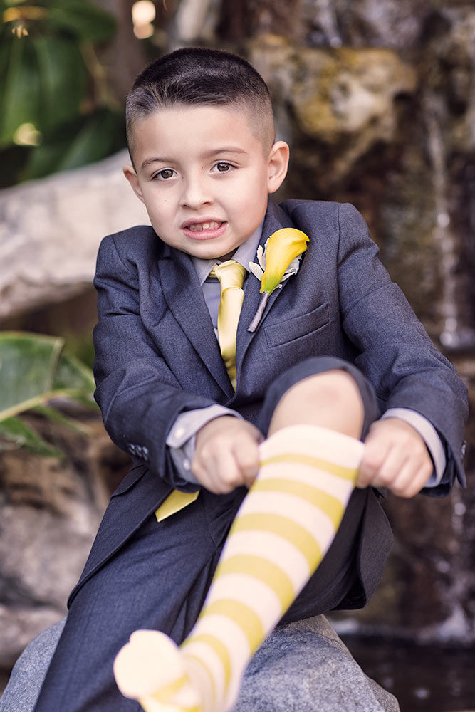 Little boy pulling up his yellow and white socks
