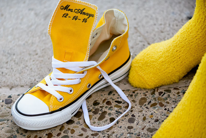 Yellow Converse with a wedding day date embroidered on the tongue