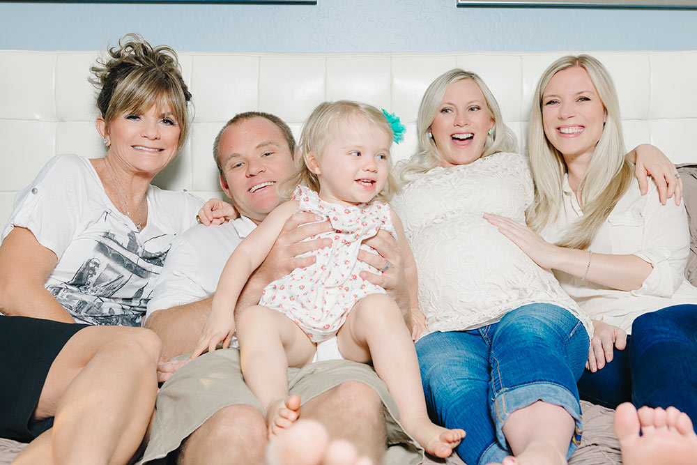 Lifestyle of a family shoot laying on the bed giggling and having fun