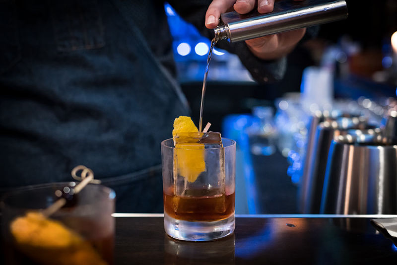 Bartender pouring a Manhattan