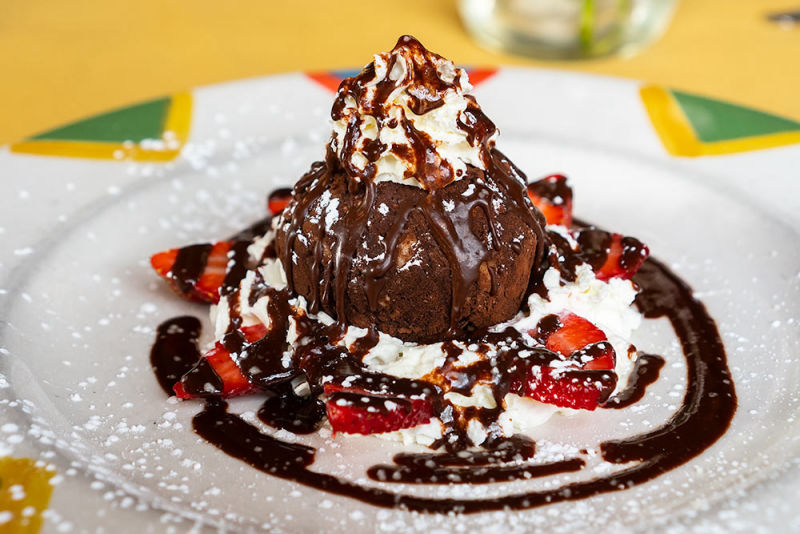 Chocolate cake with strawberry drizzled with melted chocolate