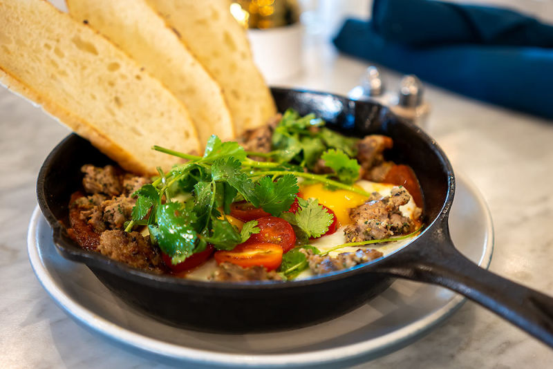 Skillet with meat and veggies with bread