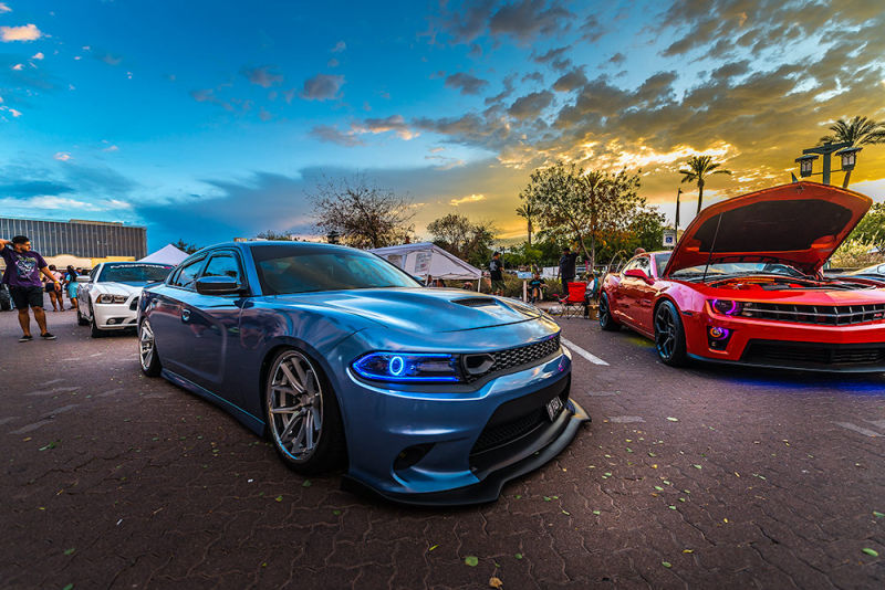 A blue and red sports car duo at a car show
