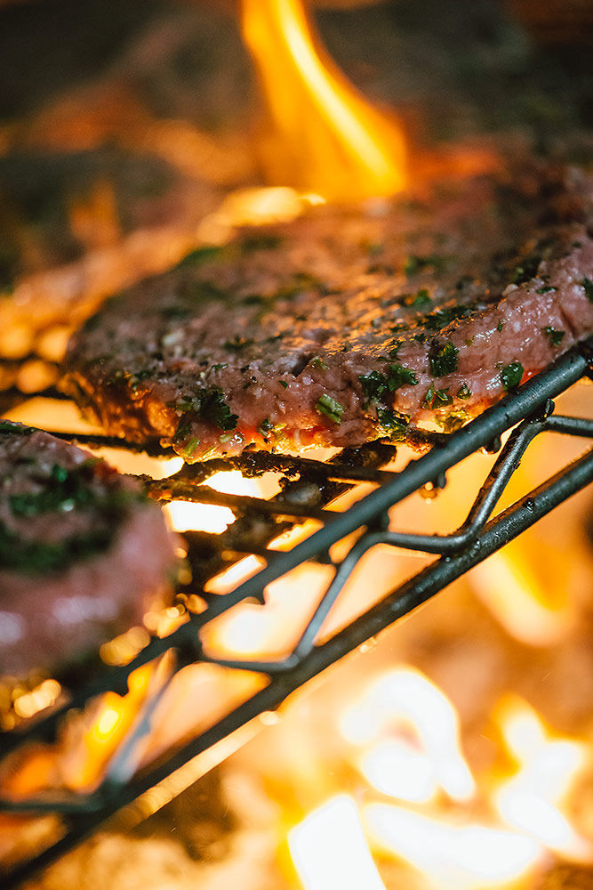 BBQ hamburgers with orange flames