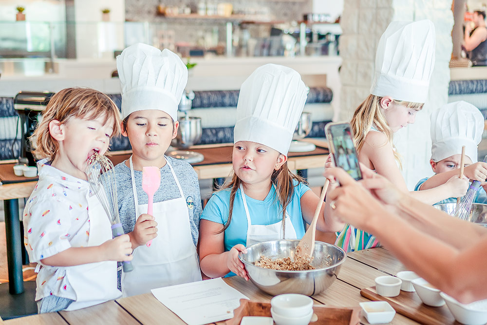 A gathering of children at a baking lesson