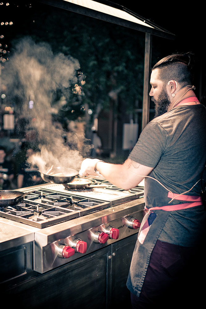 Chef cookoff action flipping skillet with smoke pouring out