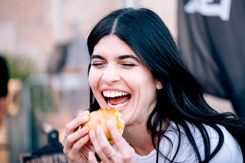 Young lady enjoying a hamburger