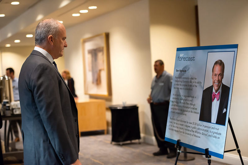 Event goer glancing over speaker credentials