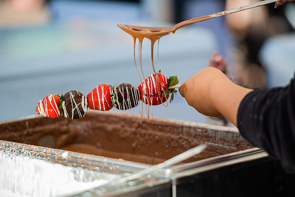 Pouring chocolate over strawberries