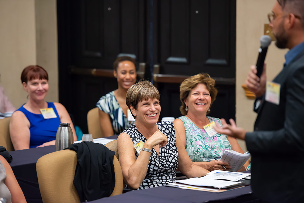 Lady in crowd laughs during speaking event