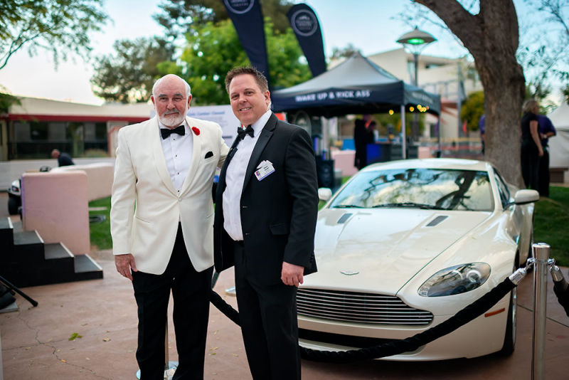 Sean Connery poses in front of high end automobile