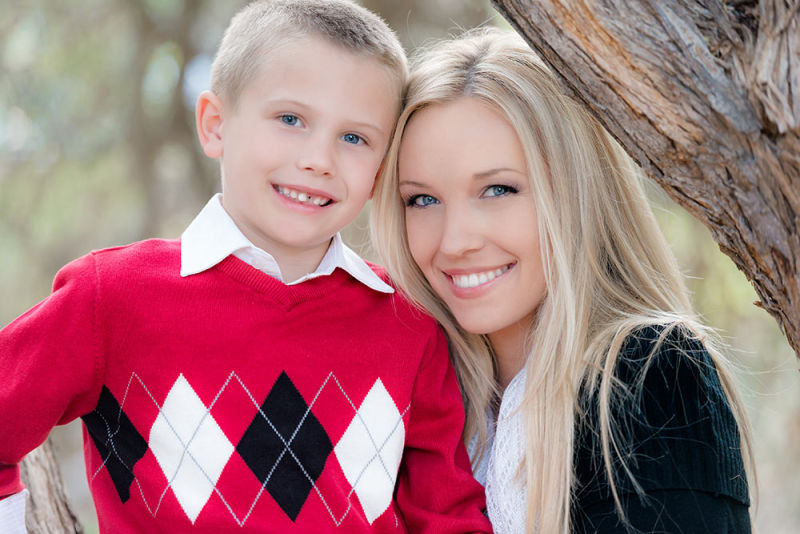 Mother and son happily posing for a photo during Christmas time