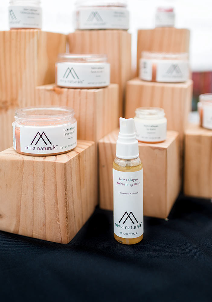 M+A Naturals line of products set upon wooden blocks