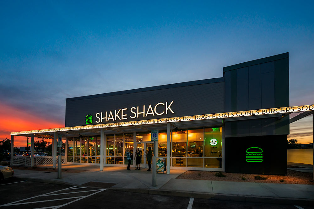 A night time view of a Shake Shack restaurant in Gilbert Arizona
