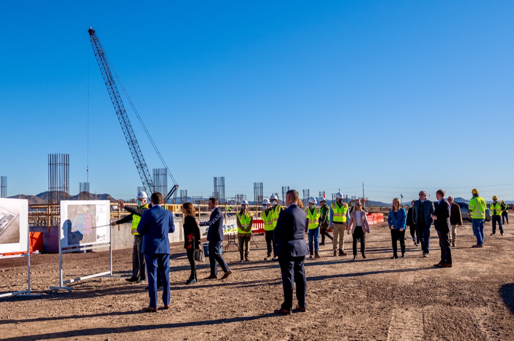 Project team site walk past a briefing board on the TSMC Arizona construction site in Phoenix — photo 5