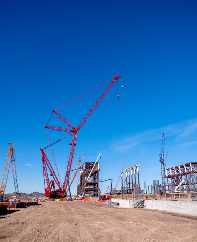 Red crawler crane over the TSMC Arizona construction site in Phoenix — photo 7