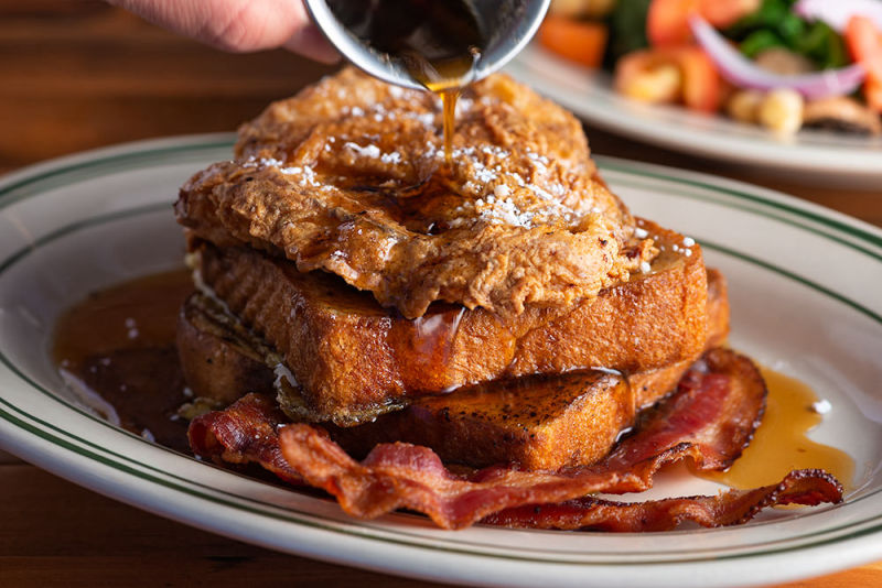 Pouring syrup over french toast